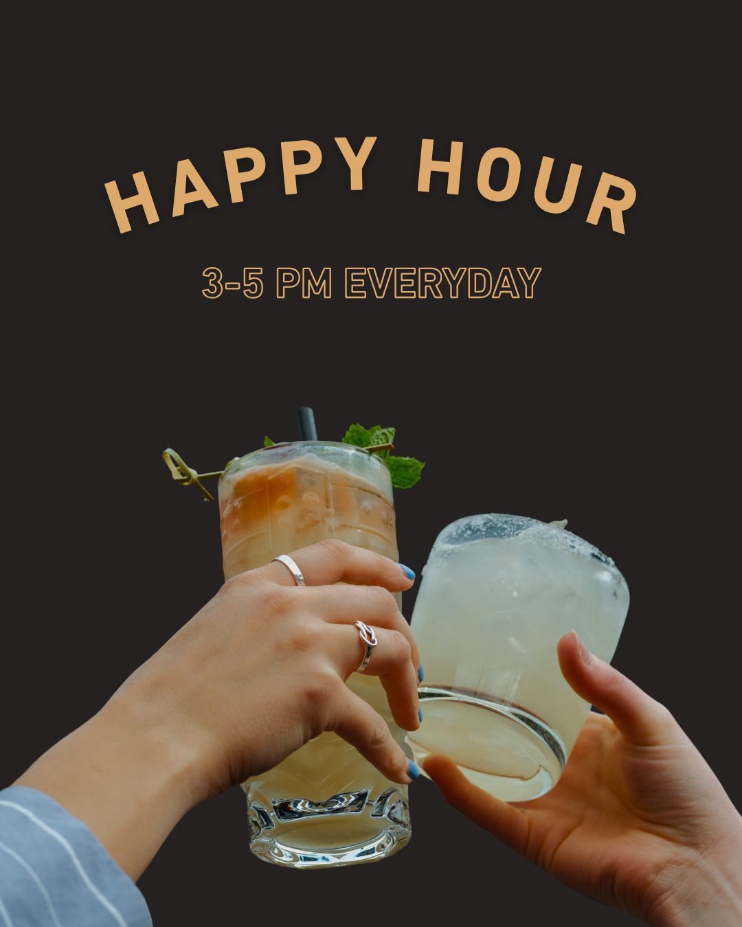Happy hour, 3 to 5pm every day: two cocktails raised in a toast