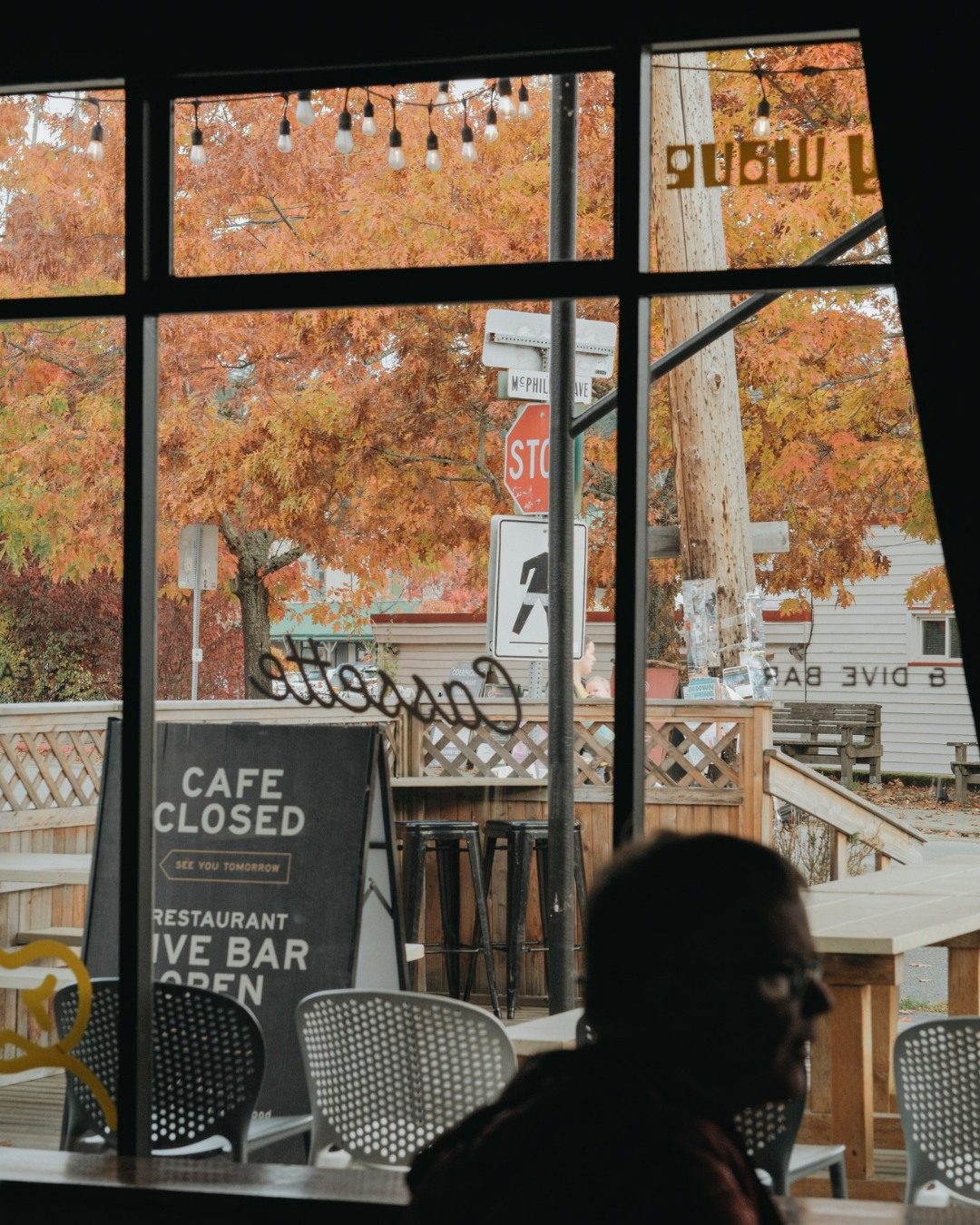 Fall colours through the window and the sandwich board outside